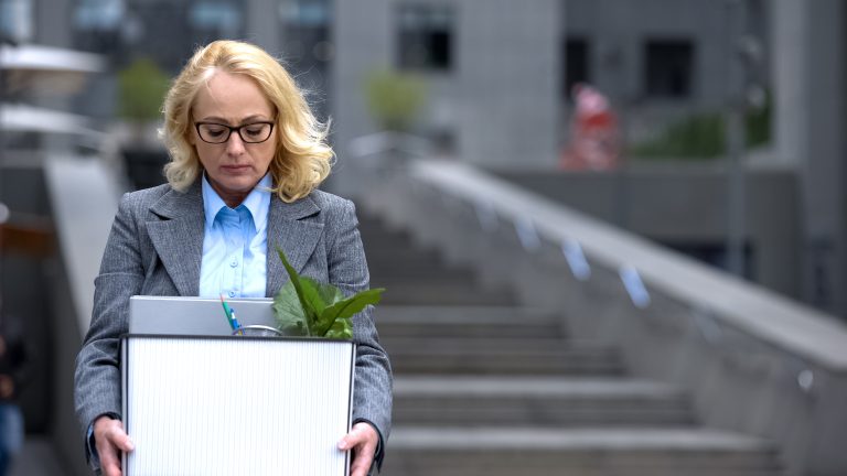 office woman carrying a box of his office stuff