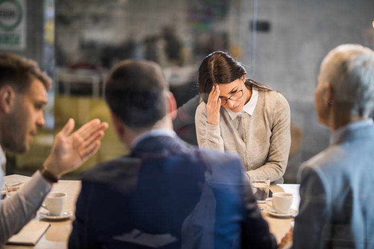 Young frustrated woman failed on a job interview in the office.