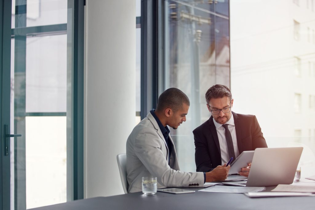 Business owners reviewing commercial insurance renewal documents