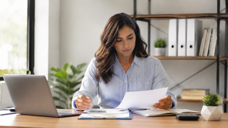 A small business owner reviewing insurance coverage options at a desk